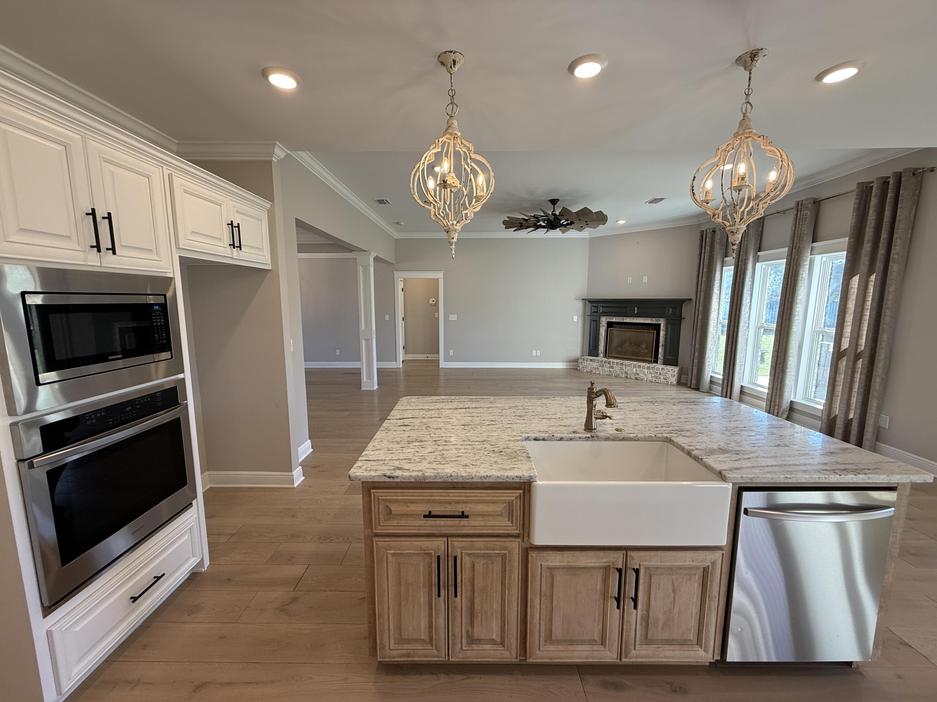 79 Mill Pond Cove Freeport, FL 32439 - Photo 52 of 63 a kitchen with stainless steel appliances granite countertop a sink a microwave a stove and a refrigerator