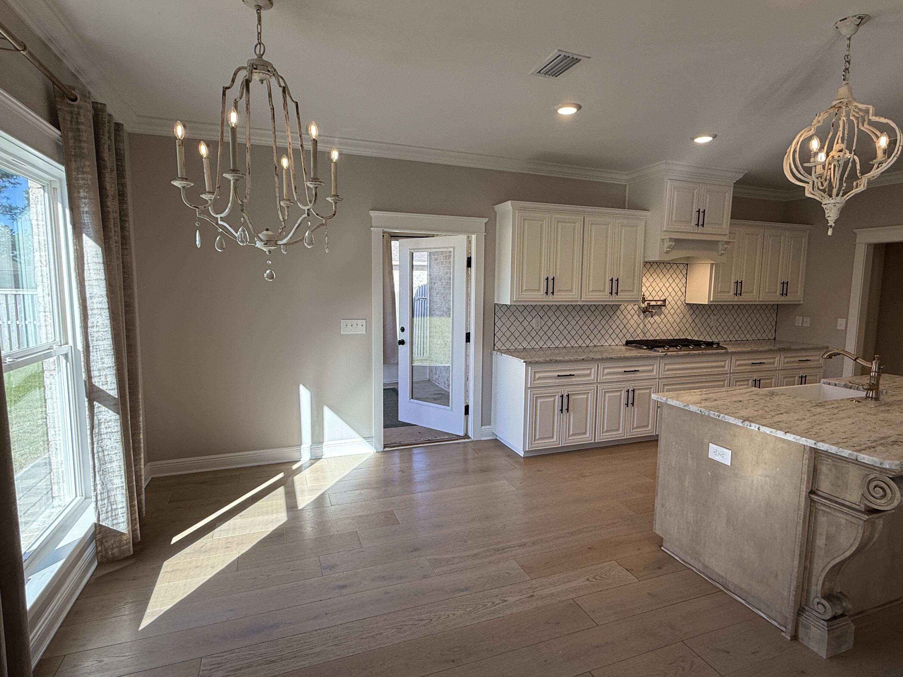 79 Mill Pond Cove Freeport, FL 32439 - Photo 54 of 63 a kitchen with kitchen island granite countertop stainless steel appliances cabinets and a counter top space