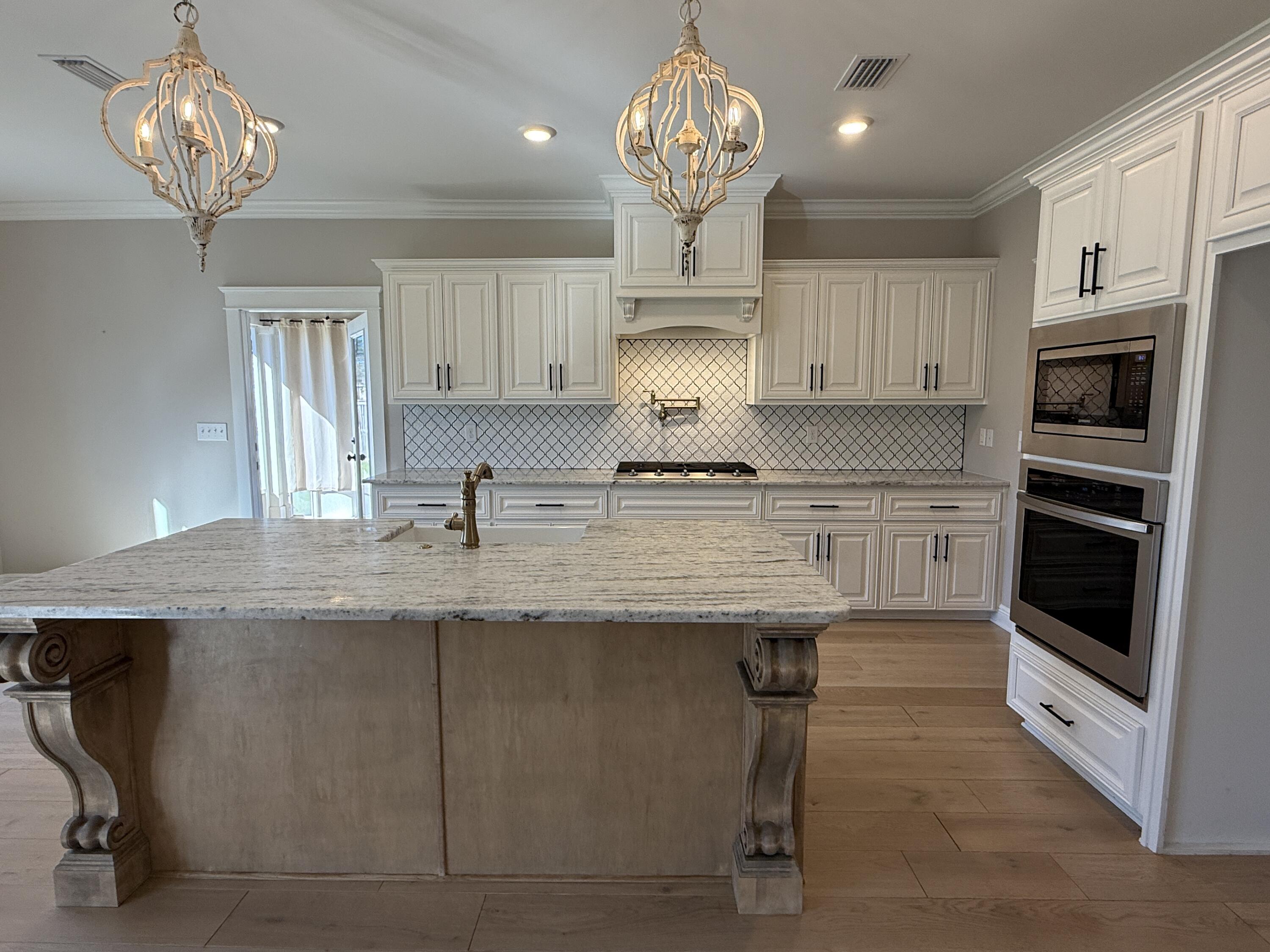 79 Mill Pond Cove Freeport, FL 32439 - Photo 55 of 63 a kitchen with stainless steel appliances granite countertop a sink a stove and a refrigerator