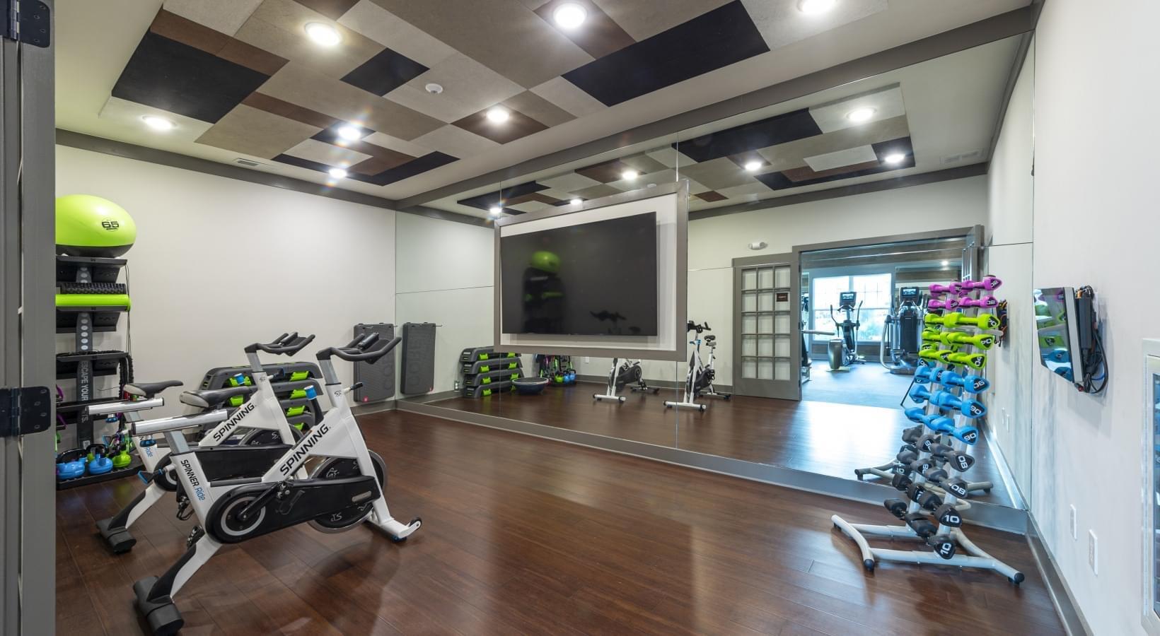 79 Mill Pond Cove Freeport, FL 32439 - Photo 63 of 63 a room with gym equipment and a chandelier