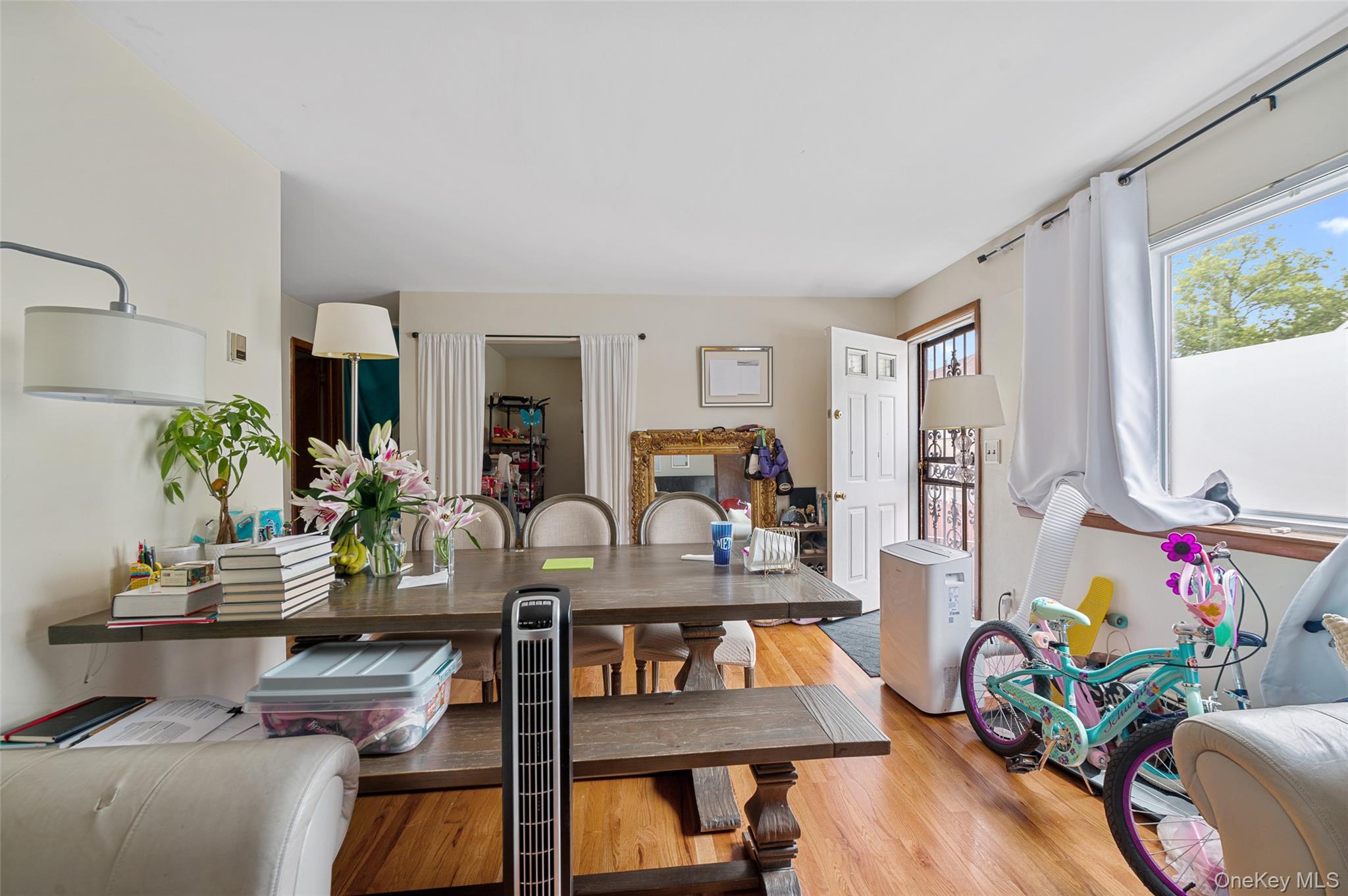 206-16 45th Road Queens, NY 11361 - Photo 6 of 12 a view of a workspace with furniture window and wooden floor