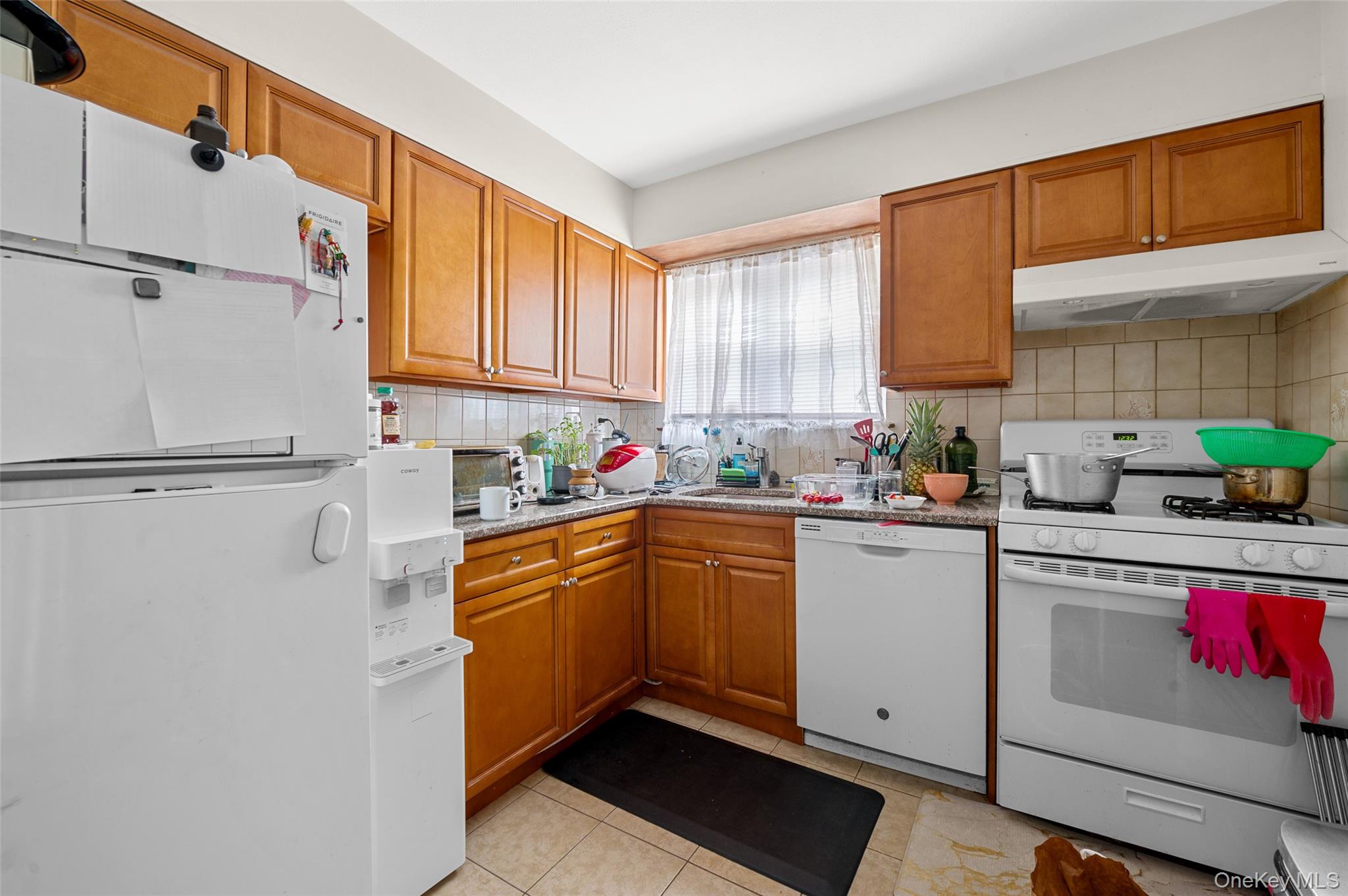 206-16 45th Road Queens, NY 11361 - Photo 7 of 12 a kitchen with granite countertop a sink stainless steel appliances and cabinets