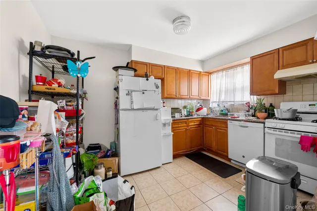 a kitchen with refrigerator and cabinets