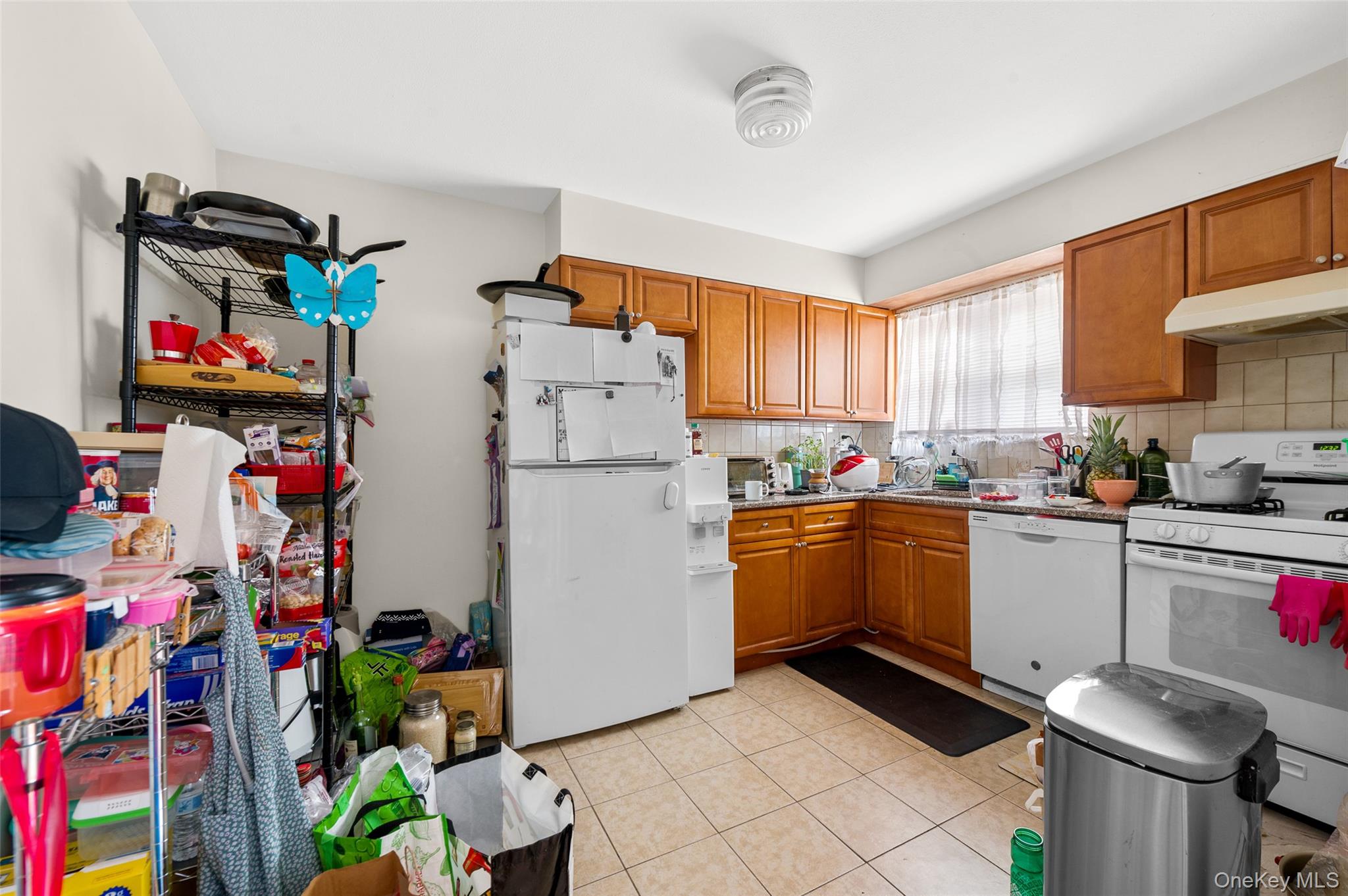 206-16 45th Road Queens, NY 11361 - Photo 8 of 12 a kitchen with refrigerator and cabinets