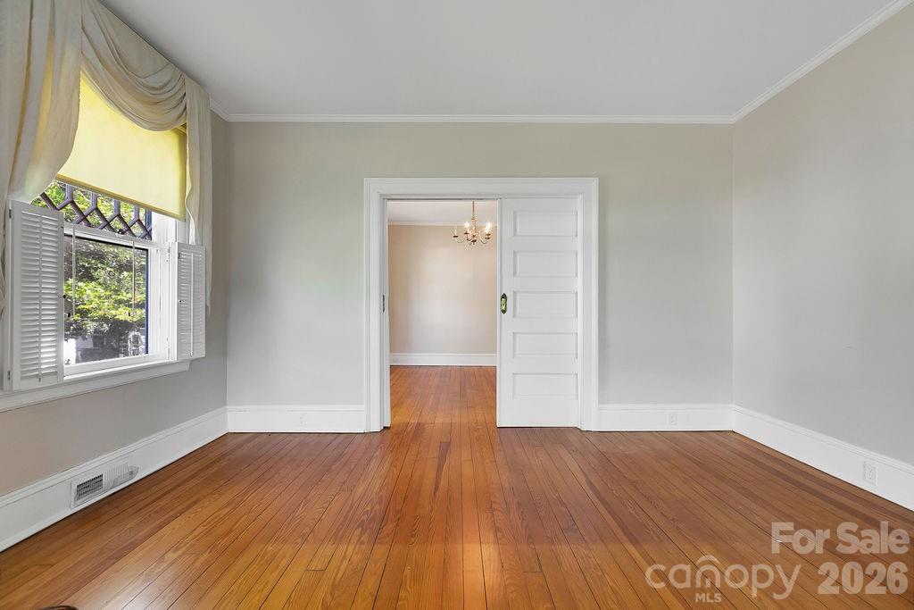 208 West Probart Street Brevard, NC 28712 - Photo 16 of 48 a view of empty room with wooden floor and fan
