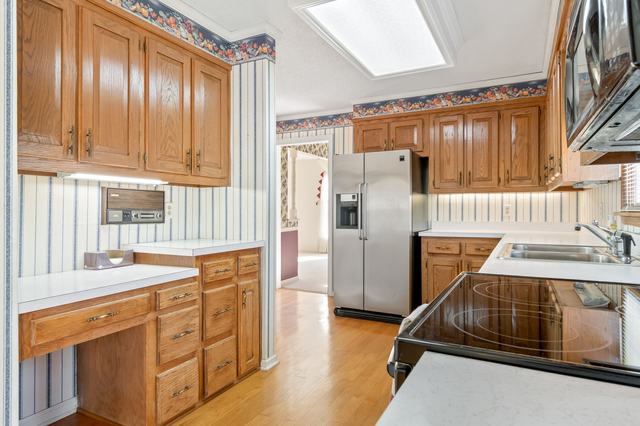 846 R Wilkerson Drive Centerville, TN 37033 - Photo 39 of 68 a kitchen with stainless steel appliances granite countertop a refrigerator a sink dishwasher a stove and white countertops with wooden floor