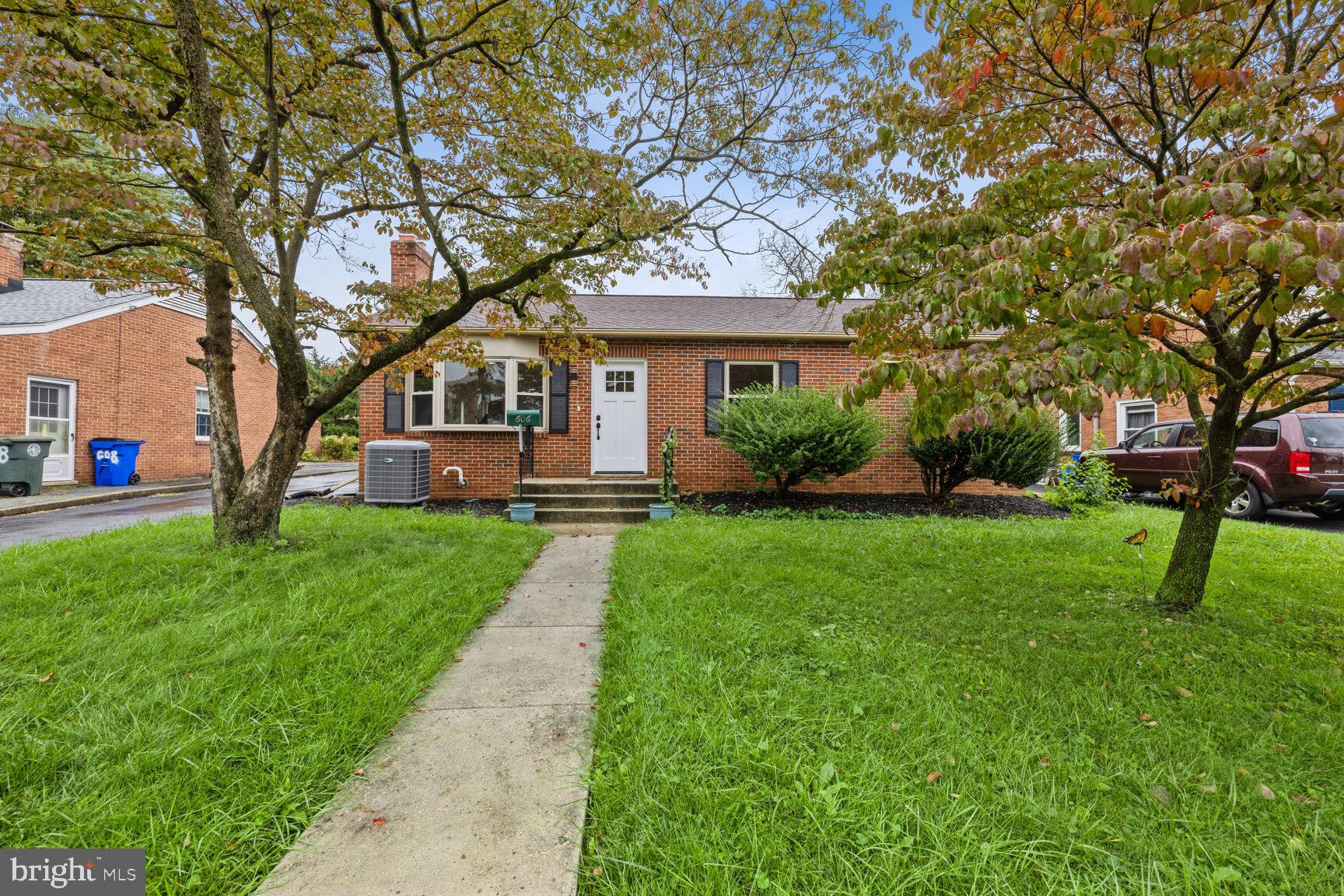 606 Biggs Avenue Frederick, MD 21702 - Photo 1 of 20 a front view of a house with garden