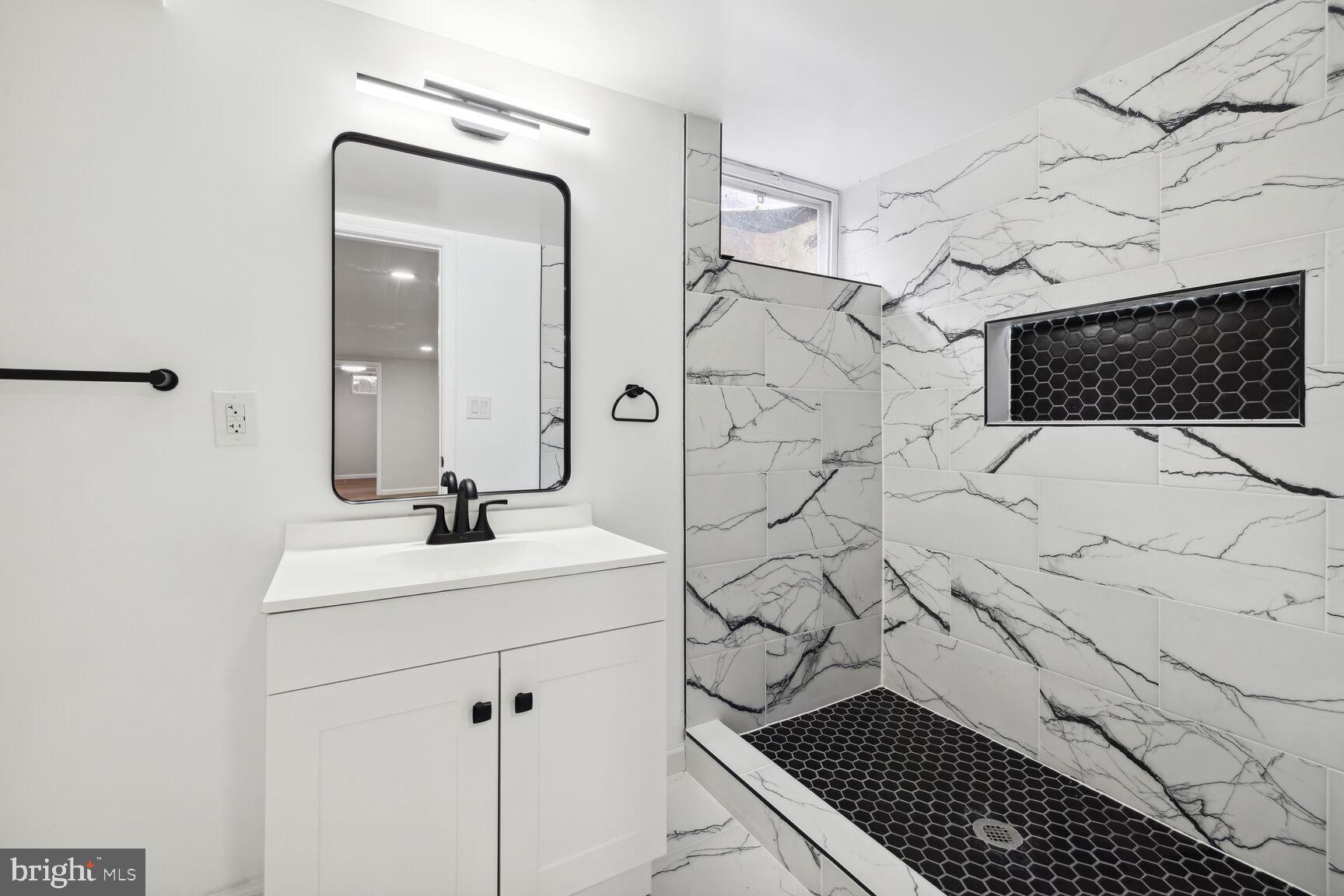 606 Biggs Avenue Frederick, MD 21702 - Photo 12 of 20 a bathroom with a sink toilet and shower