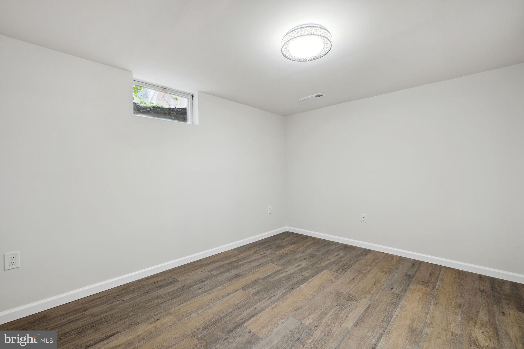 606 Biggs Avenue Frederick, MD 21702 - Photo 14 of 20 a view of a room with wooden floor and white walls