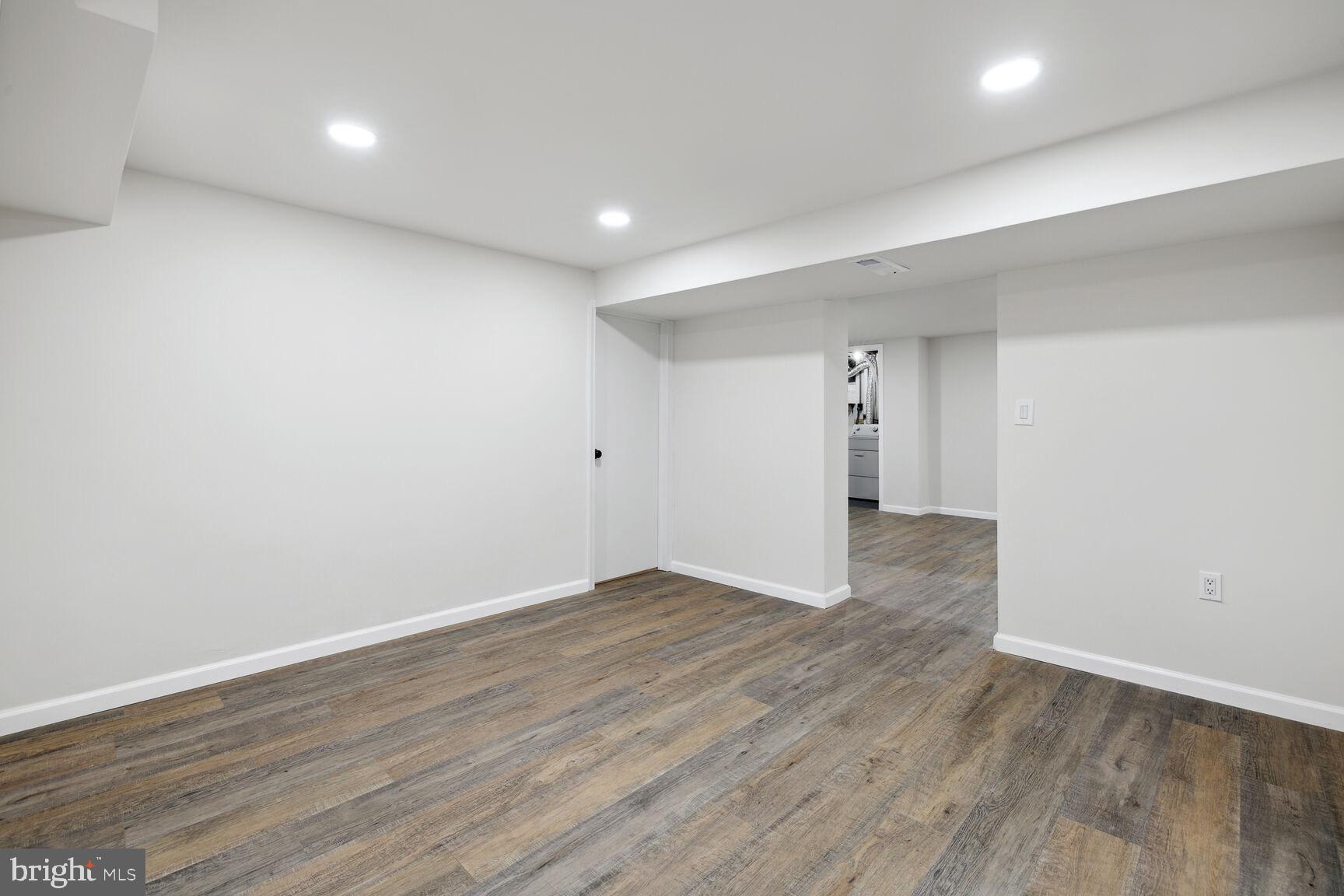 606 Biggs Avenue Frederick, MD 21702 - Photo 16 of 20 a view of an empty room with wooden floor