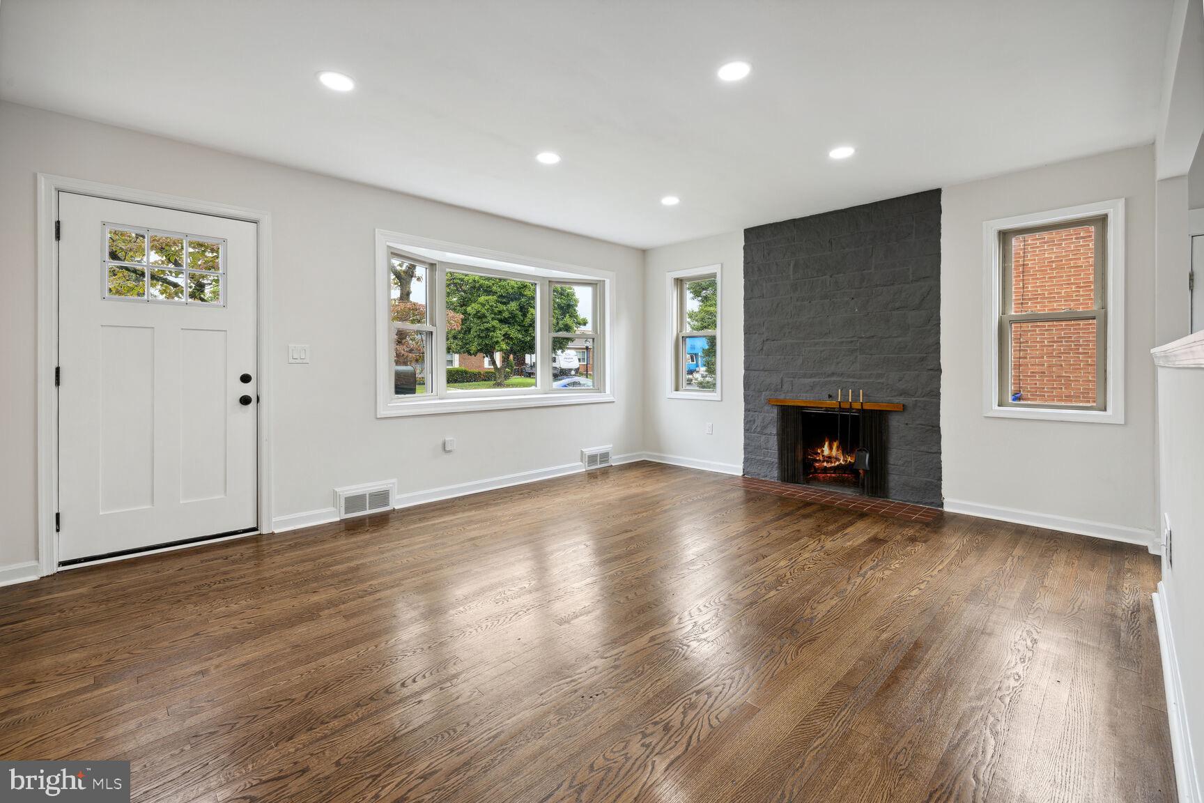 606 Biggs Avenue Frederick, MD 21702 - Photo 2 of 20 an empty room with windows and fireplace