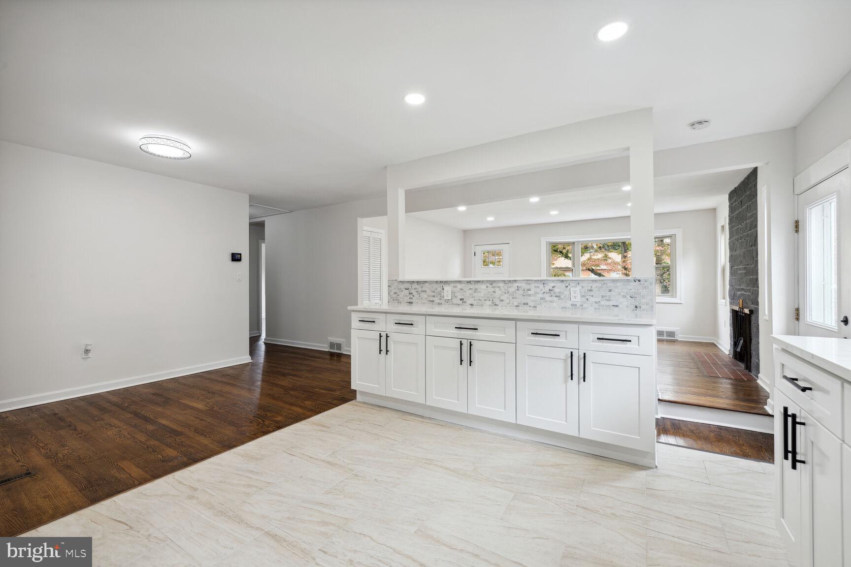606 Biggs Avenue Frederick, MD 21702 - Photo 5 of 20 a kitchen with granite countertop white cabinets and white appliances
