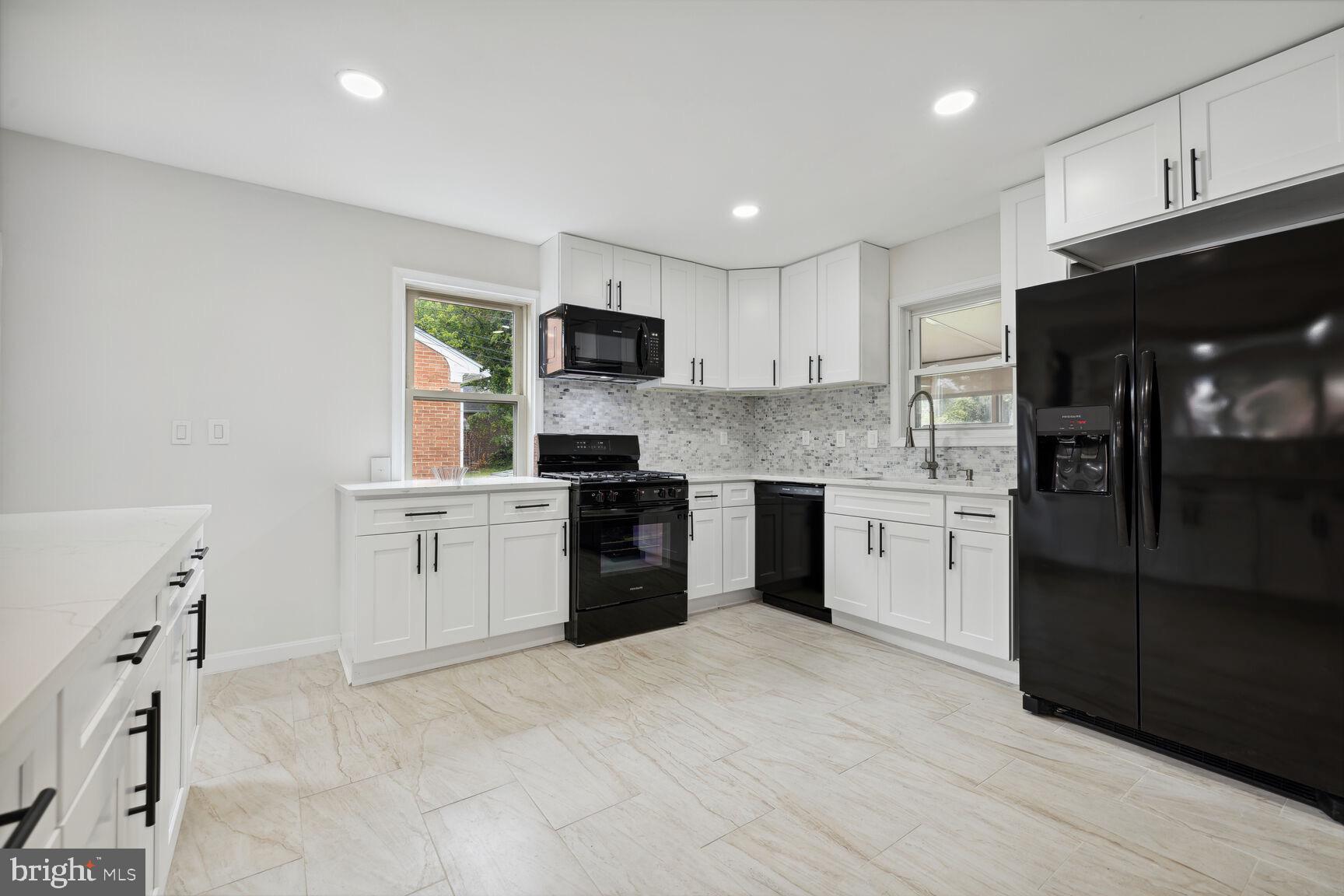 606 Biggs Avenue Frederick, MD 21702 - Photo 6 of 20 a kitchen with a sink a counter top space stainless steel appliances and cabinets