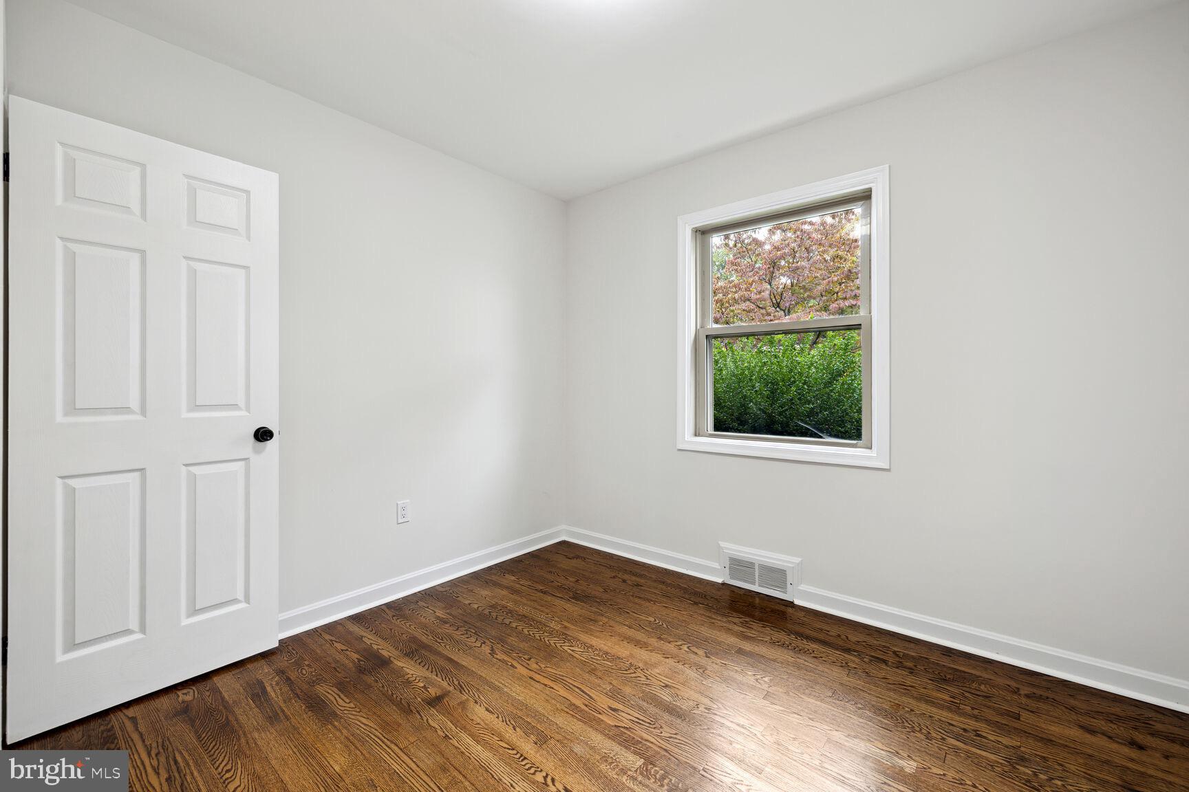 606 Biggs Avenue Frederick, MD 21702 - Photo 7 of 20 a view of empty room with wooden floor and fan