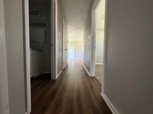 a view of a hallway with wooden floor