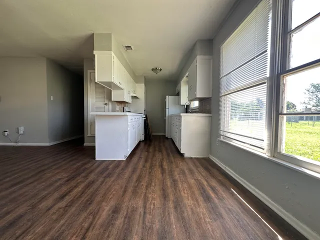 wooden floor in an empty room with a window and wooden floor