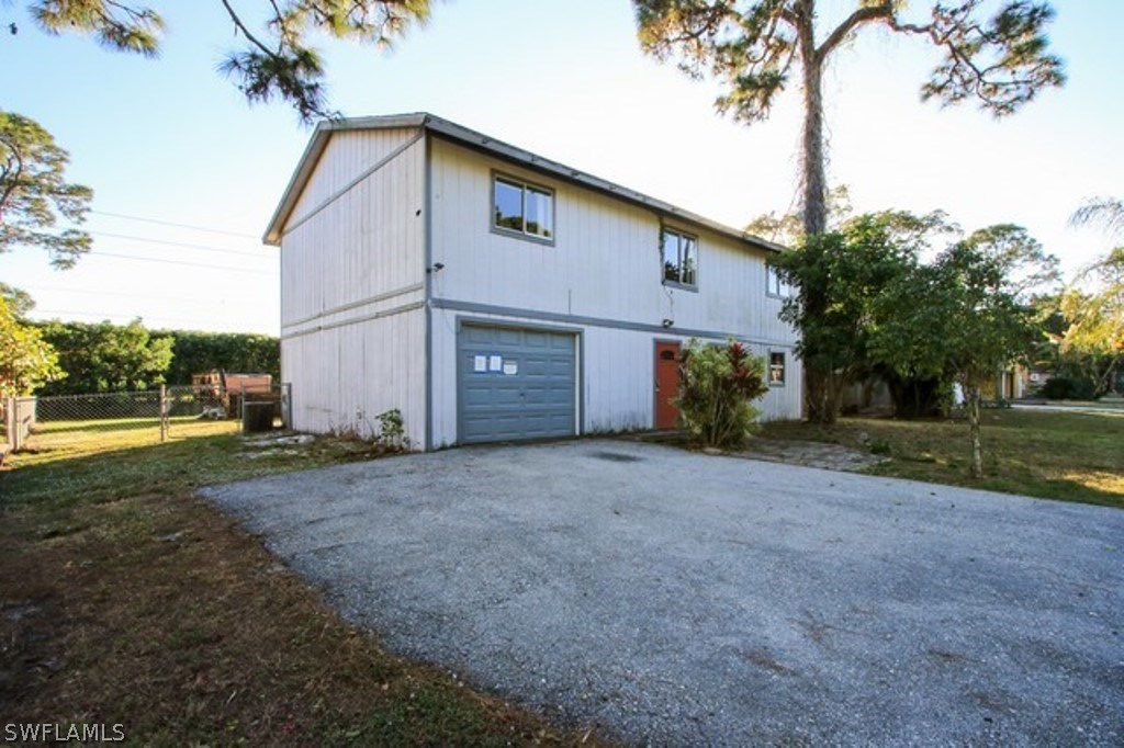 8070 Matanzas Road Fort Myers, FL 33967 - Photo 3 of 25 a front view of a house with a yard and garage
