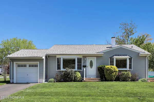 a front view of house with yard and green space
