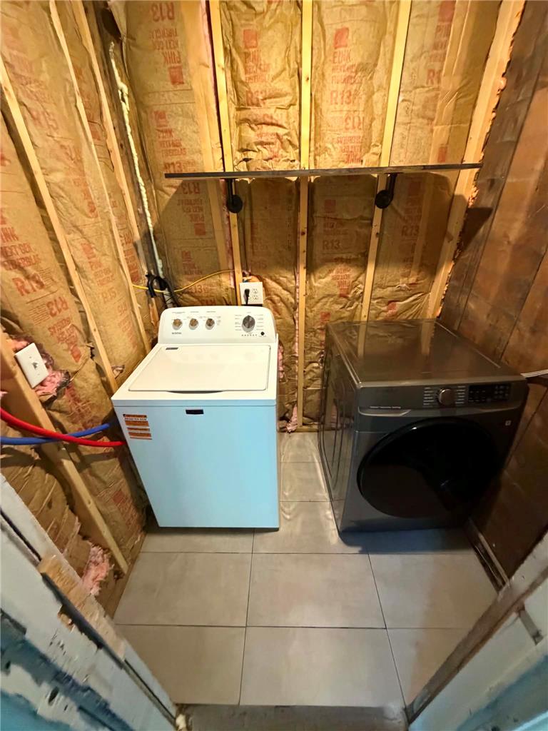 164 Sand Spring Road Cresco, PA 18326 - Photo 52 of 60 A dedicated utility space houses contemporary laundry appliances, optimizing functional living.