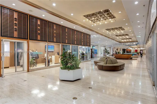 a lobby with furniture and potted plants