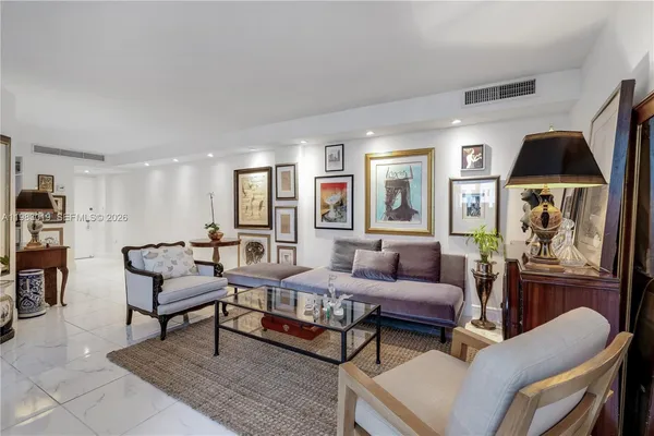 a living room with furniture fireplace and a window