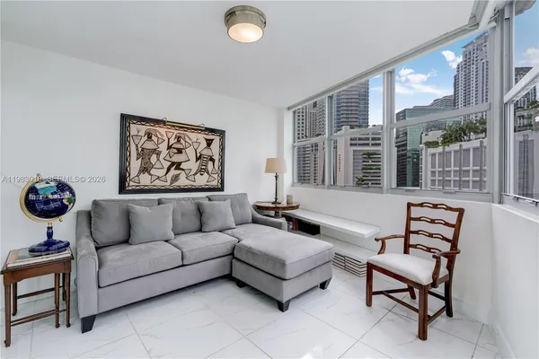 a living room with furniture a rug and a wall painting