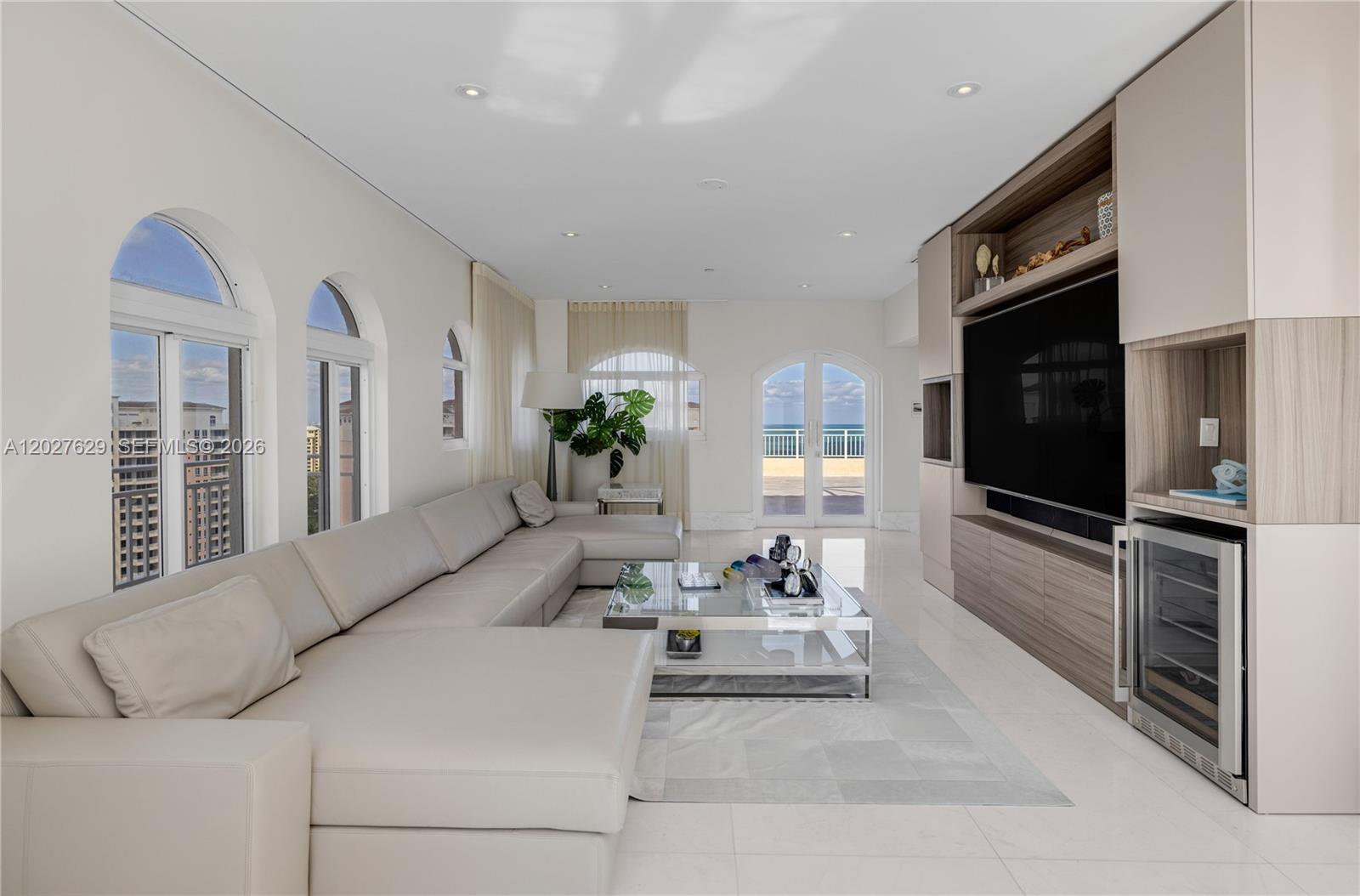 799 Crandon Boulevard, Unit PH8 Key Biscayne, FL 33149 - Photo 21 of 47 a living room with furniture fireplace and flat screen tv