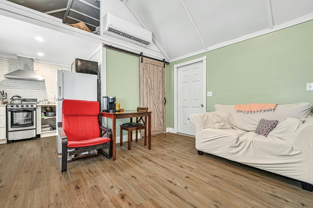 210 New Boston Road Sturbridge, MA 01566 - Photo 30 of 42 a bedroom with furniture and wooden floor