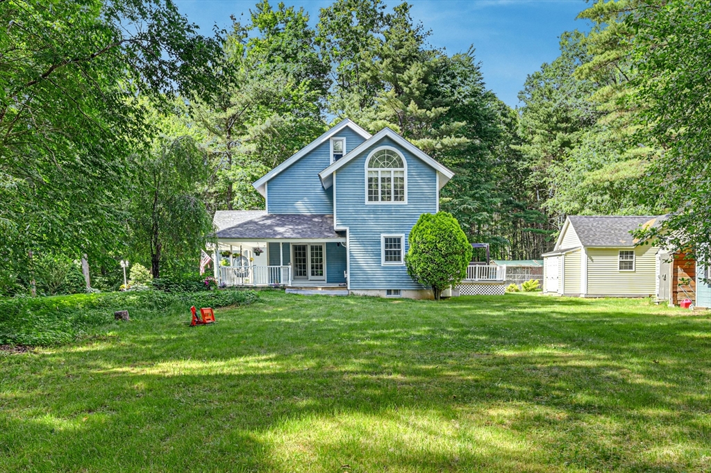 210 New Boston Road Sturbridge, MA 01566 - Photo 39 of 42 a front view of a house with a yard and trees