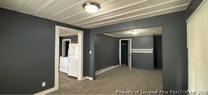 a view of a hallway with wooden shelves