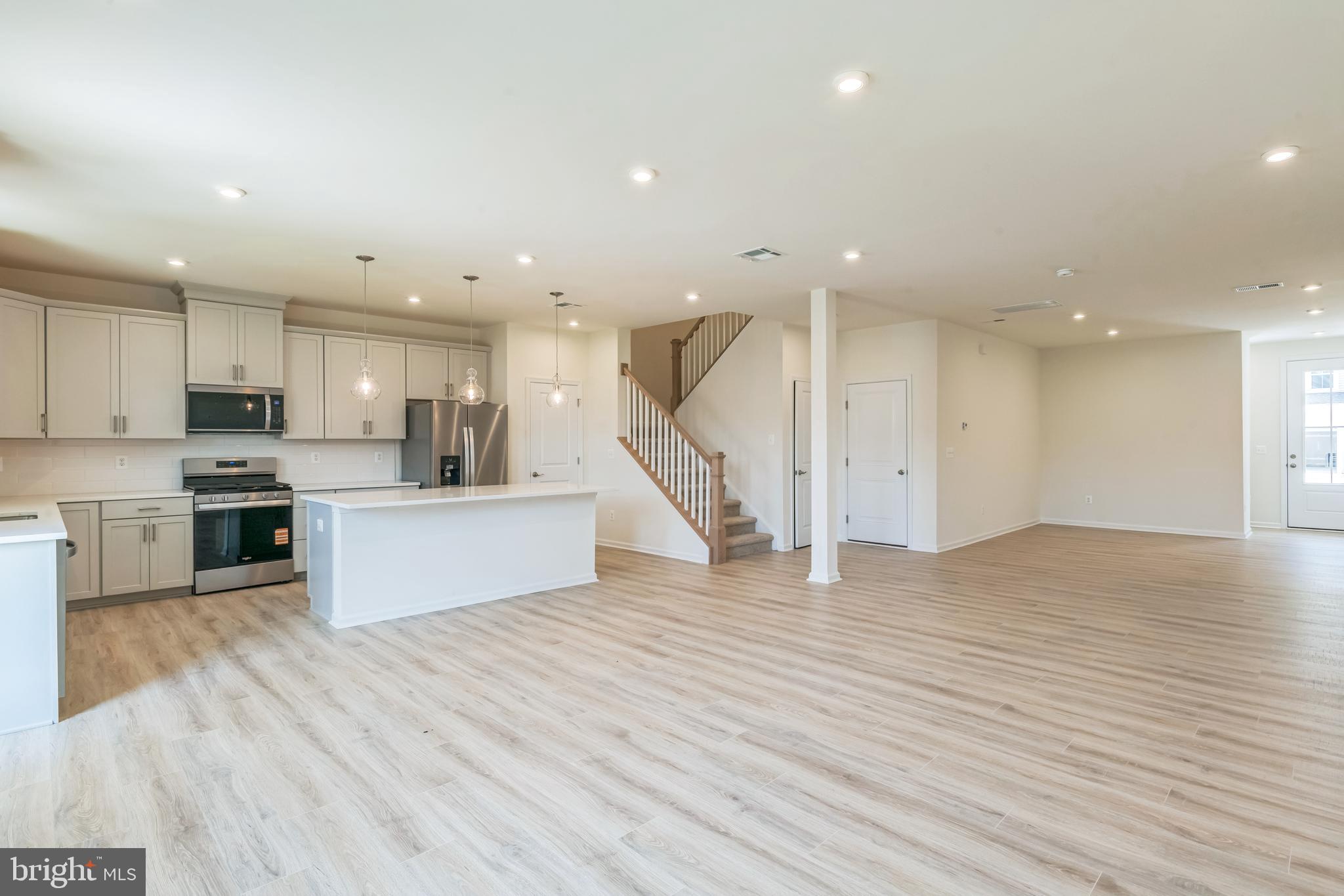392 Scranton Lane Ocean View, DE 19970 - Photo 4 of 15 a large kitchen with stainless steel appliances kitchen island a large counter top and a stove top oven
