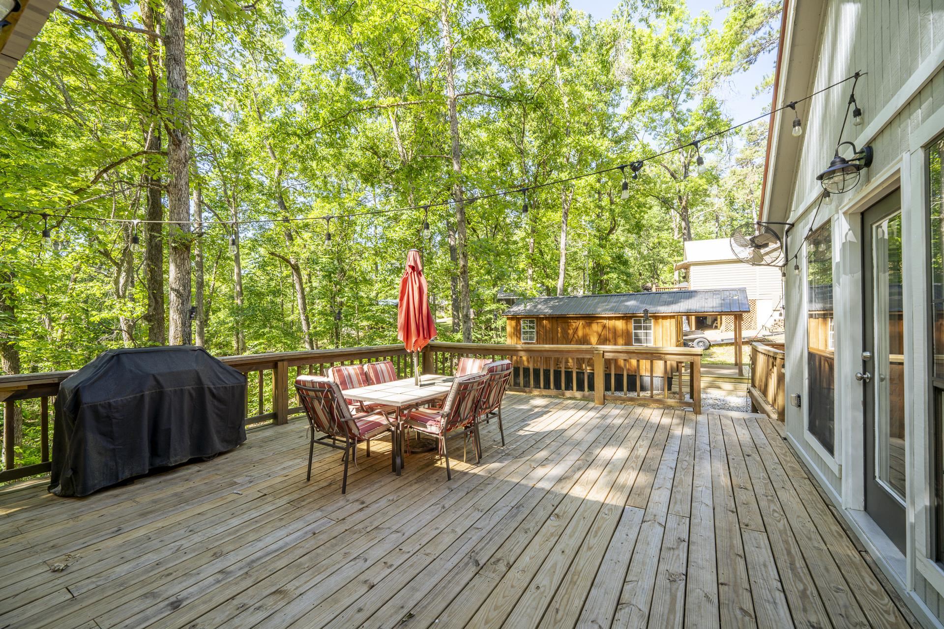80 Contreau Road Counce, TN 38326 - Photo 24 of 28 a view of a roof deck with table and chairs and wooden floor