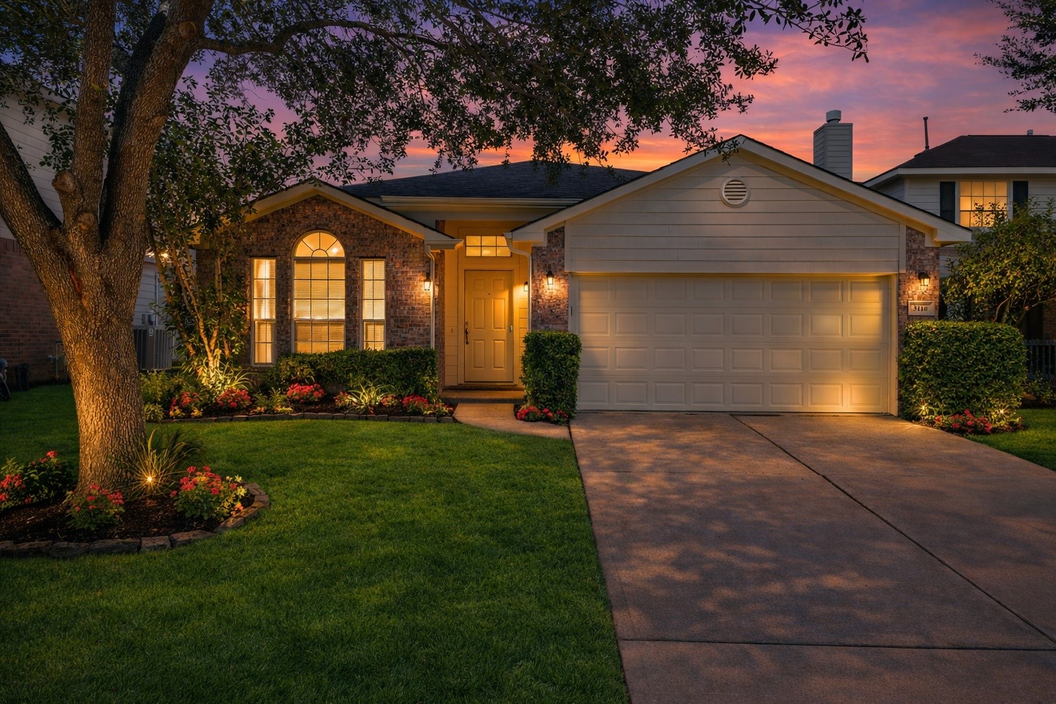 a front view of a house with a garden