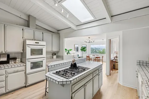 a kitchen with stove and white cabinets