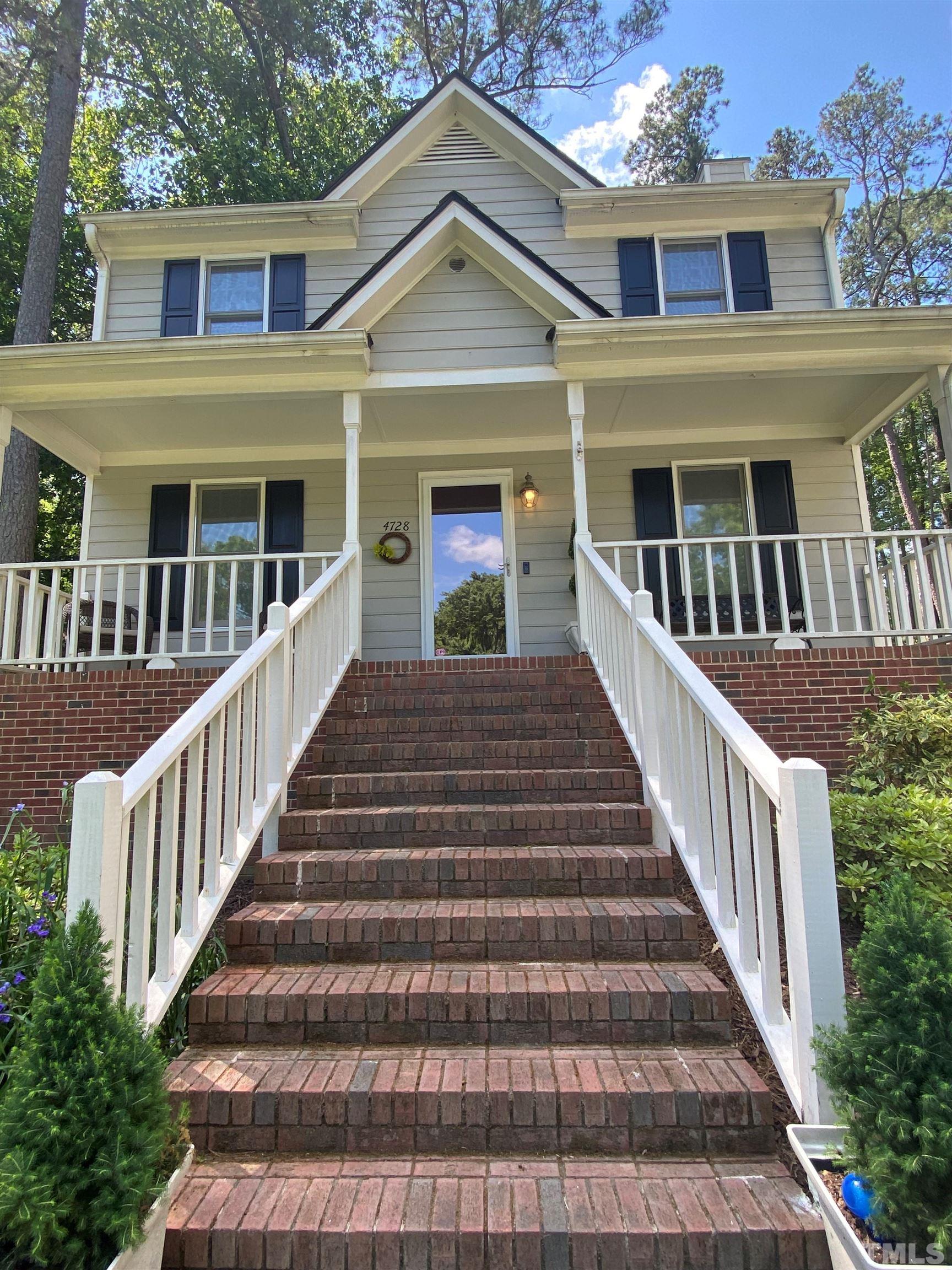 a view of a house with wooden fence and large windows