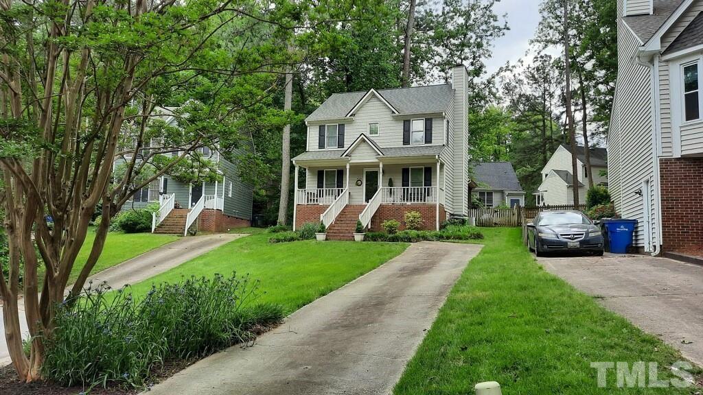 4728 Worchester Place Raleigh, NC 27604 - Photo 3 of 7 a front view of a house with a garden and trees