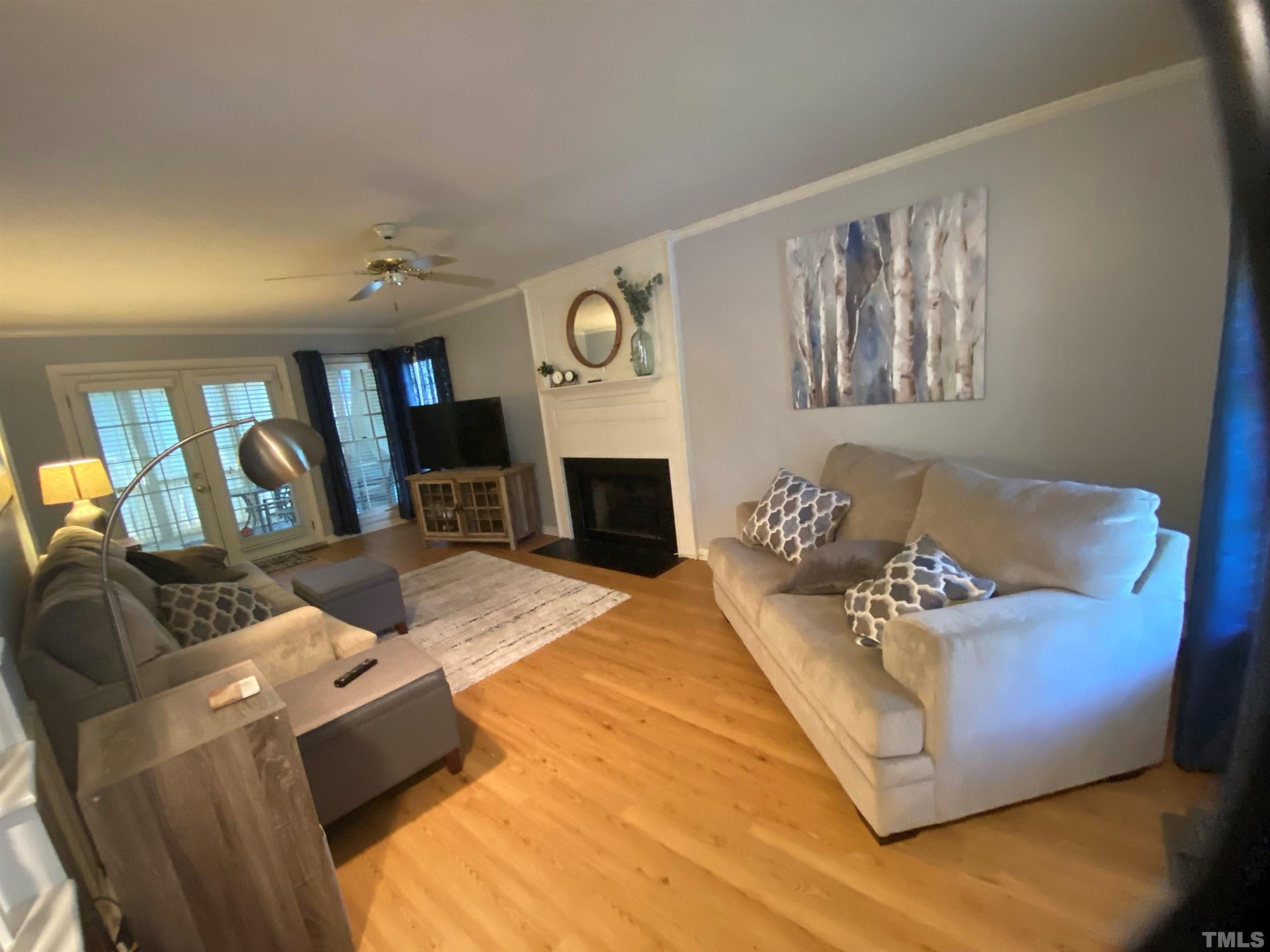 4728 Worchester Place Raleigh, NC 27604 - Photo 4 of 7 a living room with furniture window and a fireplace