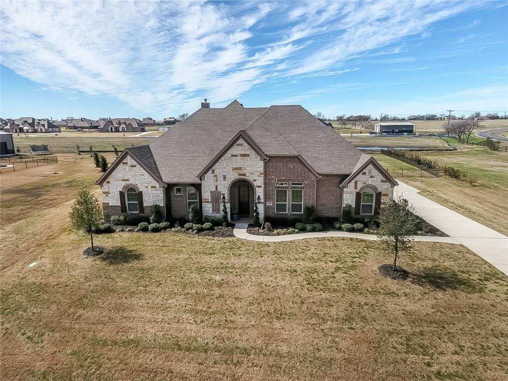 9100 Avery Ranch Way Justin, TX 76247 - Photo 1 of 1 an aerial view of a house with swimming pool and large trees