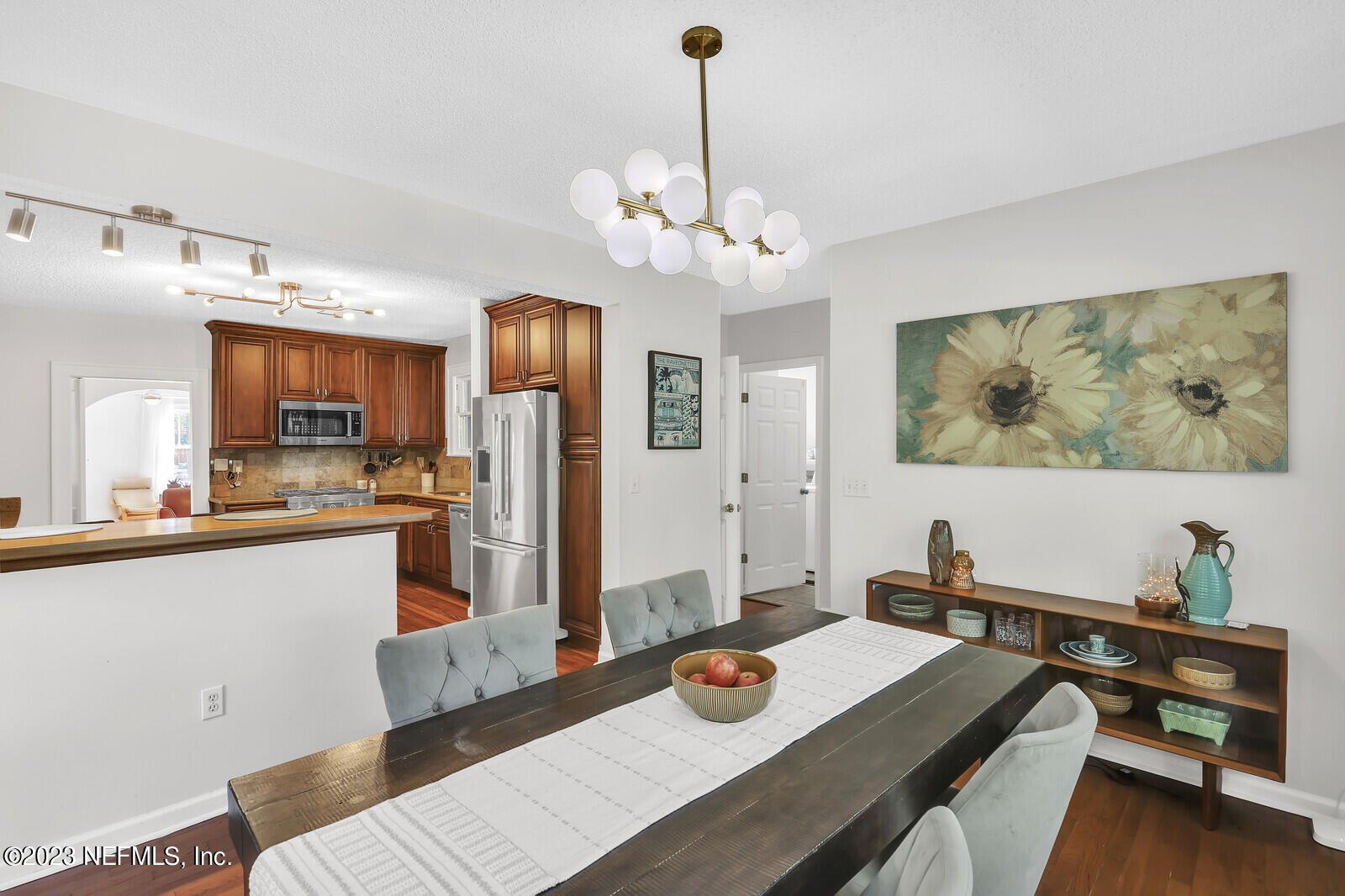 3803 Valencia Road Jacksonville, FL 32205 - Photo 11 of 58 a living room with stainless steel appliances kitchen island furniture and a chandelier