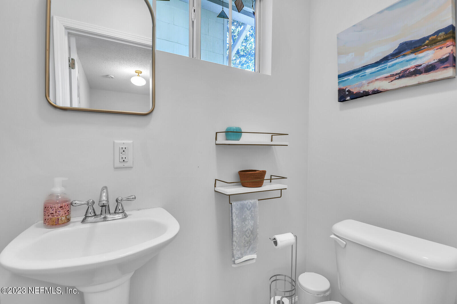 3803 Valencia Road Jacksonville, FL 32205 - Photo 19 of 58 a bathroom with a toilet a sink and mirror