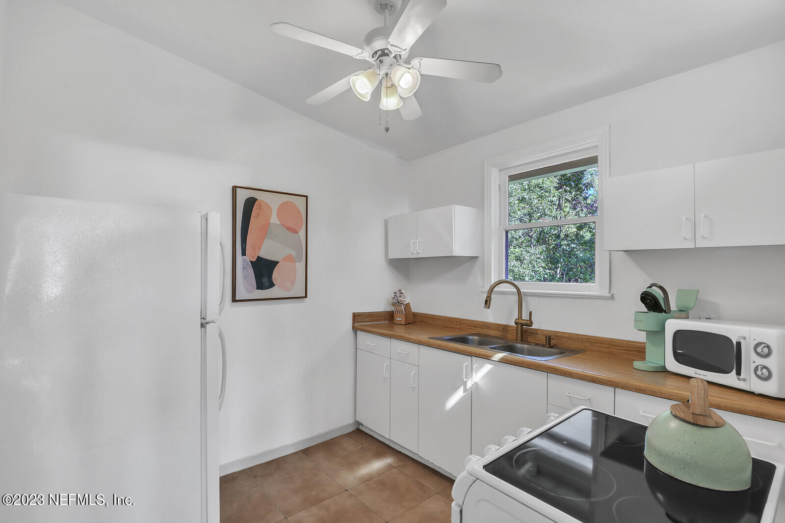 3803 Valencia Road Jacksonville, FL 32205 - Photo 26 of 58 a kitchen with a sink cabinets and window