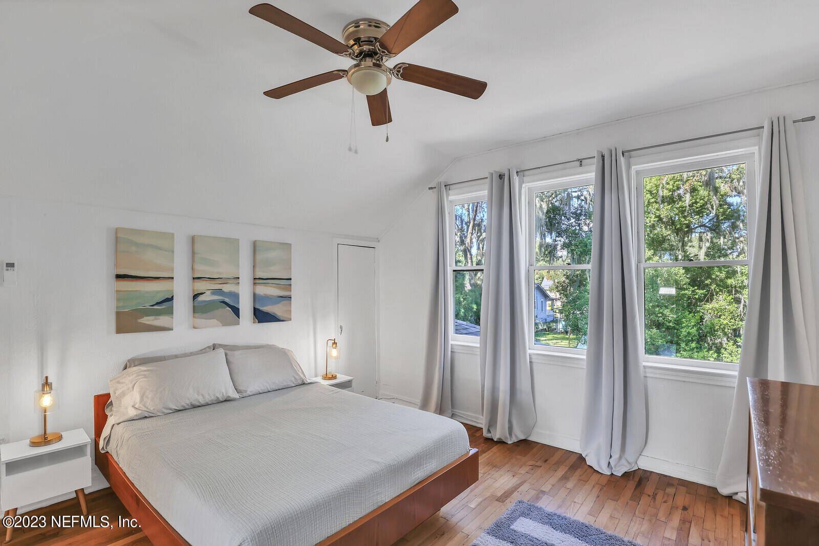 3803 Valencia Road Jacksonville, FL 32205 - Photo 27 of 58 a bedroom with a large bed and a large window