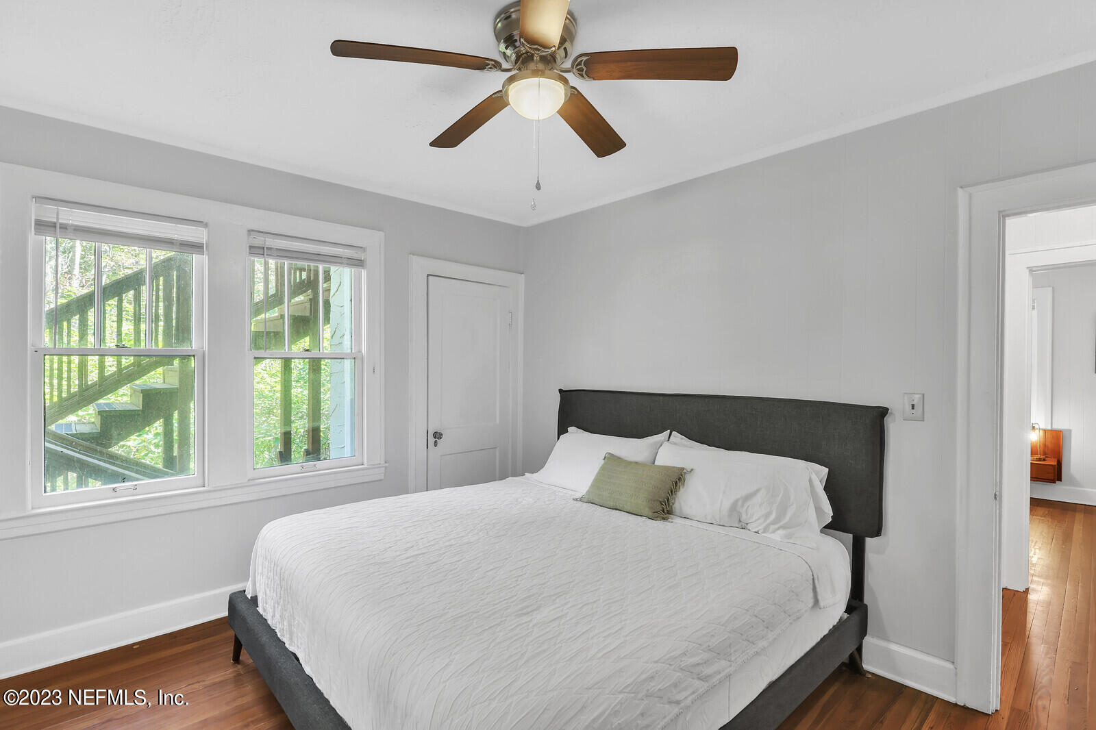 3803 Valencia Road Jacksonville, FL 32205 - Photo 4 of 58 a bedroom with a large bed and a chandelier fan