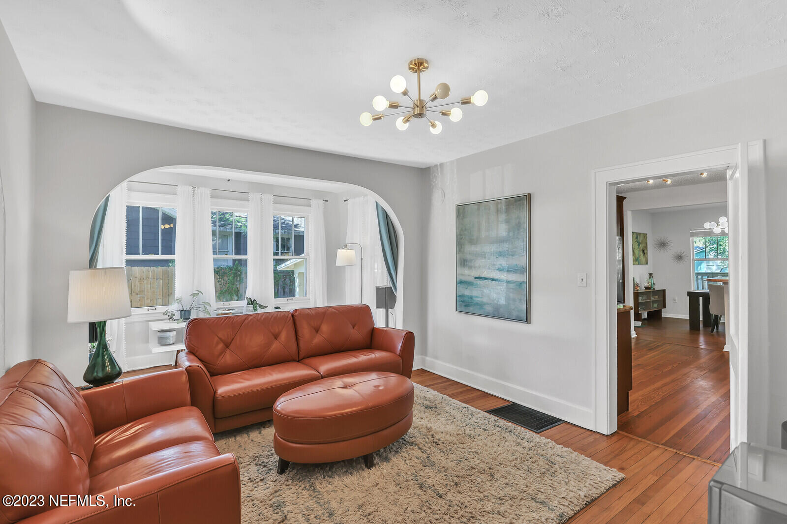 3803 Valencia Road Jacksonville, FL 32205 - Photo 8 of 58 a living room with furniture and a chandelier
