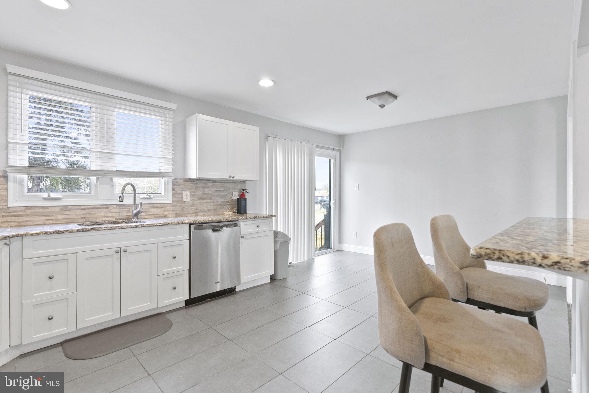 3 Birch Avenue Berlin, NJ 08009 - Photo 9 of 35 a open kitchen with granite countertop a sink and white cabinets