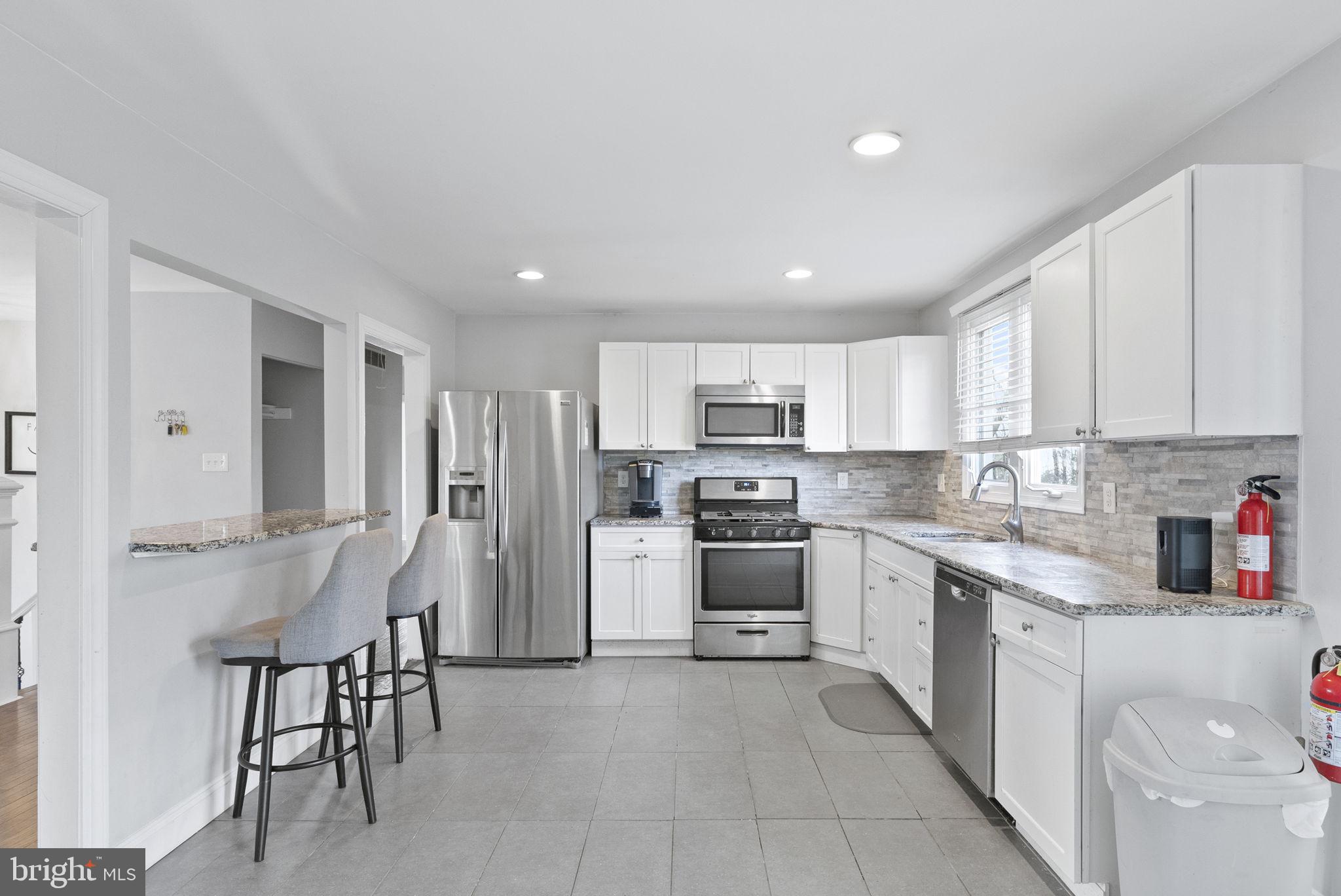 3 Birch Avenue Berlin, NJ 08009 - Photo 10 of 35 a kitchen with white cabinets and stainless steel appliances
