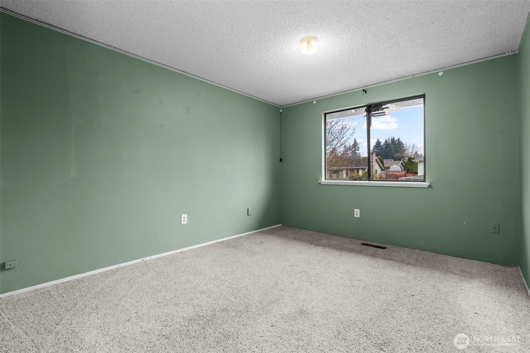 10329 99th Street Southwest Tacoma, WA 98498 - Photo 11 of 25 an empty room with a window and painting on the wall
