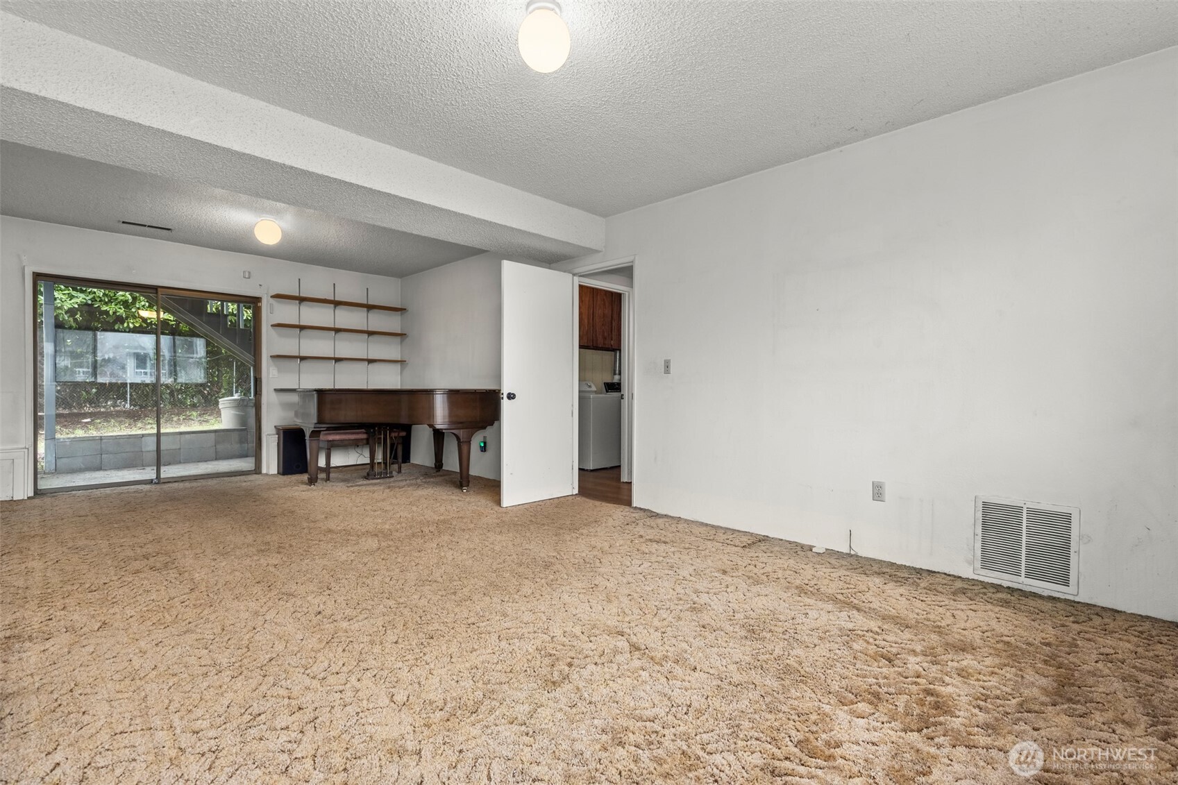 10329 99th Street Southwest Tacoma, WA 98498 - Photo 15 of 25 an empty room with a fireplace and window