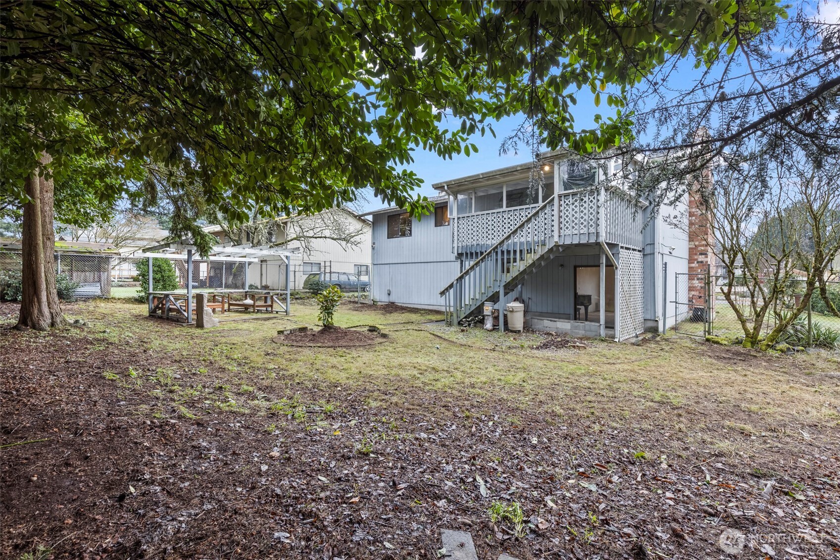 10329 99th Street Southwest Tacoma, WA 98498 - Photo 23 of 25 a view of a house with yard and a tree