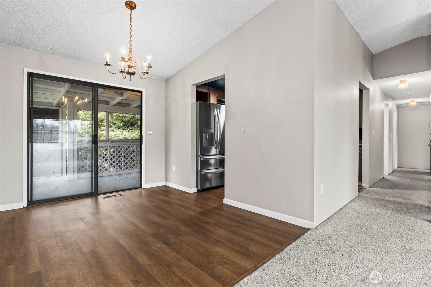 10329 99th Street Southwest Tacoma, WA 98498 - Photo 5 of 25 a view of a livingroom with wooden floor staircase and a chandelier